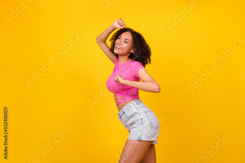 Profile portrait of overjoyed cheerful girl enjoy free time clubbing dancing isolated on yellow color background