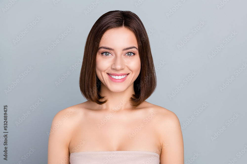 Portrait of gorgeous smiling female with bob hairstyle showing bright teeth have nude makeup isolated on grey color background Portrait of gorgeous smiling female with bob hairstyle showing bright teeth have nude makeup isolated on grey color background