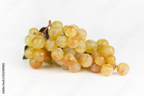 Ripe yellow grapes on a white background.