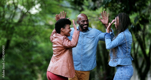 Three people celebrating success uniting group. African ethnicity