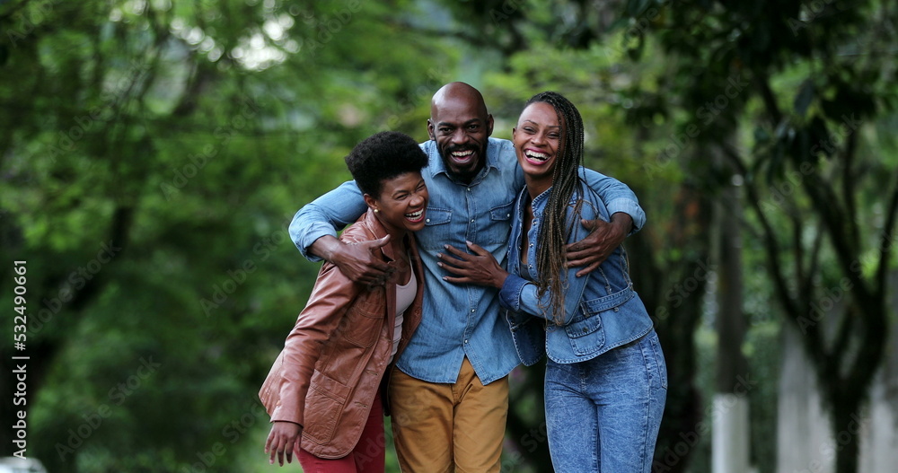 Fototapeta premium Three happy people posing together. African ethnicity, friends smiling