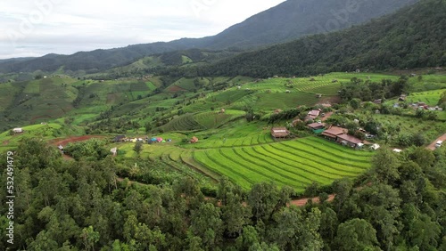 High aerial view of Pabongpaing, Chaingmai, Thailand in rainy season of green field rice farm. local travel video for create content of Thailand. 