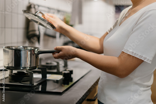 Asian woman is cooking in the kitchen