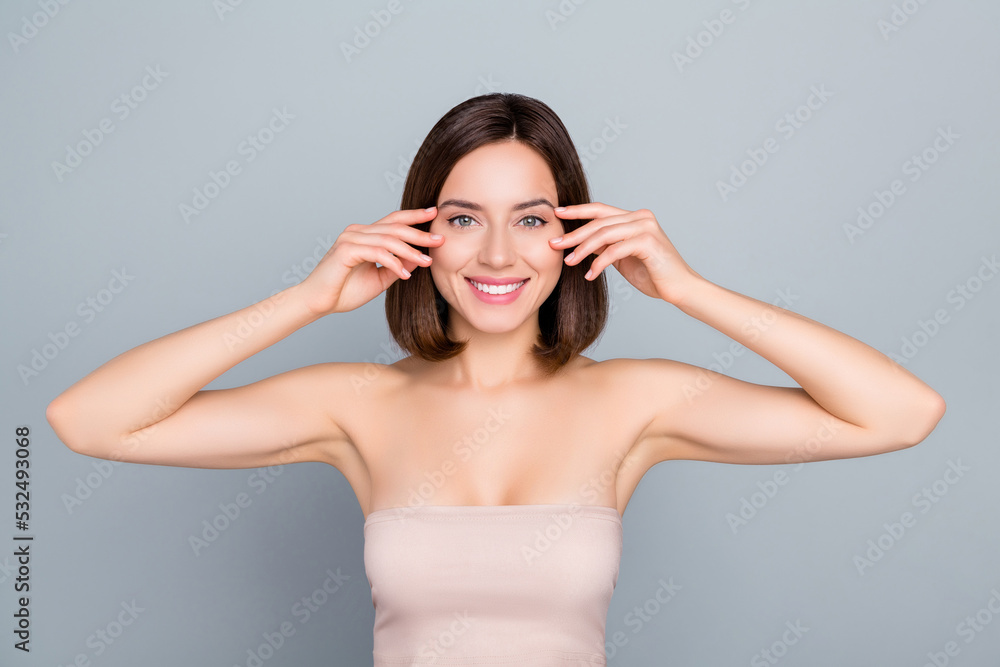 Photo of joyful lady showing eyebrows ideal perfect make up party isolated over grey color background Photo of joyful lady showing eyebrows ideal perfect make up party isolated over grey color background