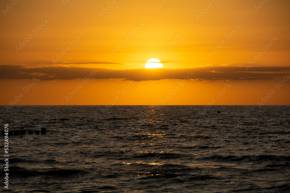 Fototapeta premium Beautiful orange sunset over the sea