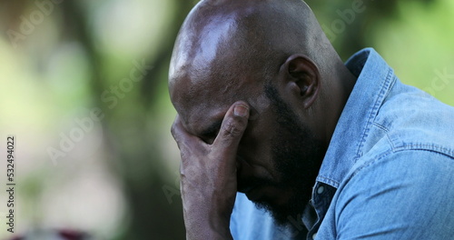 Slika na platnu Disappointed black man receiving bad negative news on cellphone