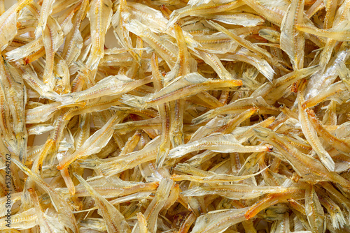 macro dried fish texture,Dried anchovies fish on white background, macro image, fill frame with brown dried anchovies.