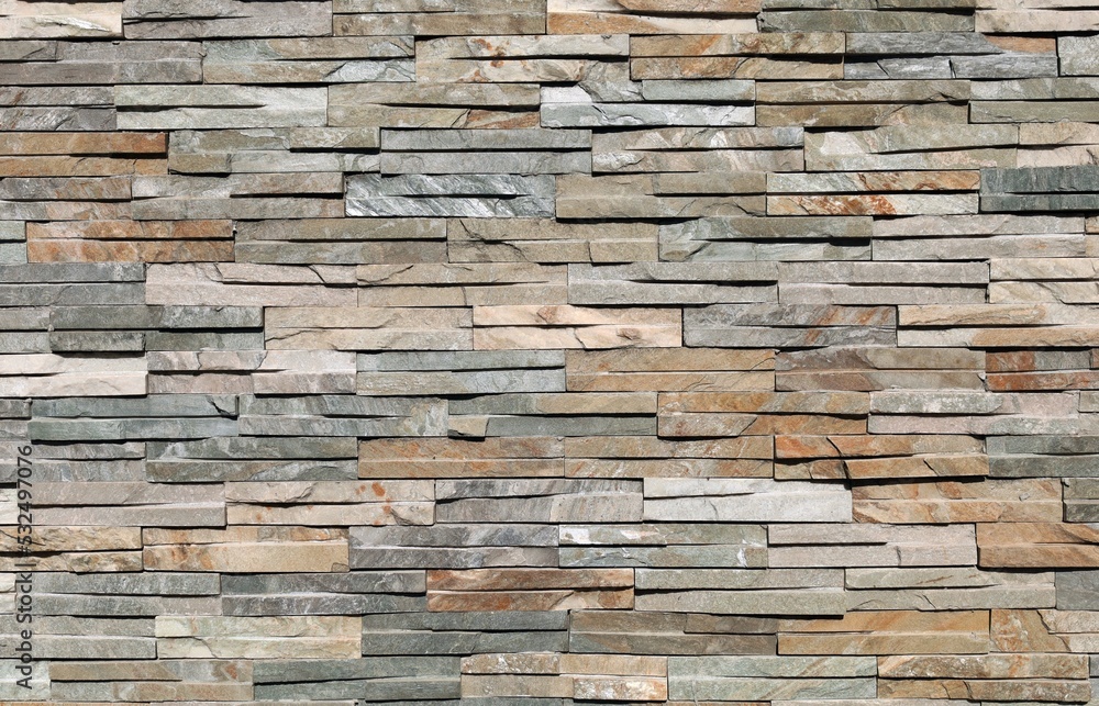 Stone cladding wall made by elongated bricks of natural multicolor