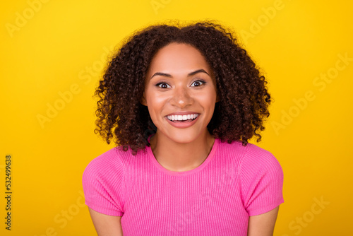 Photo of cheerful satisfied person toothy beaming smile look camera isolated on yellow color background © deagreez