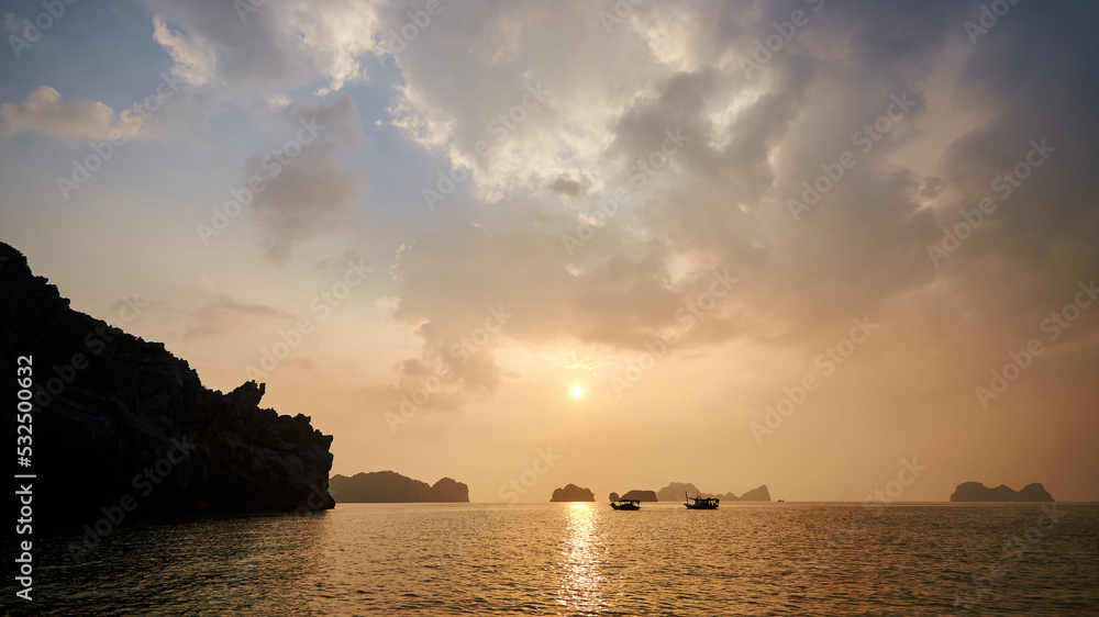 beautiful warm sunset sky over the islands in the azure sea. beautiful natural background. rocky islands in Vietnam. halong bay beautiful warm sunset sky over the islands in the azure sea. beautiful natural background. rocky islands in Vietnam. halong bay
