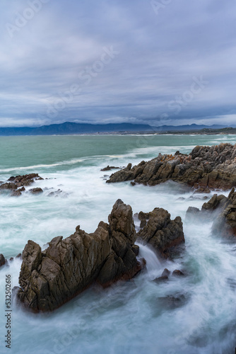 The rocky coastline of Walker Bay at De Kelders near Gansbaai in the Overberg, Western Cape. South Africa photo