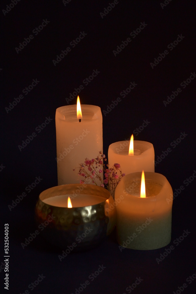 burning candles on black background burning candles on black background