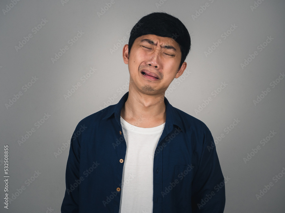 Obraz premium Asian man feels depressed and crying about unhappy life isolated
