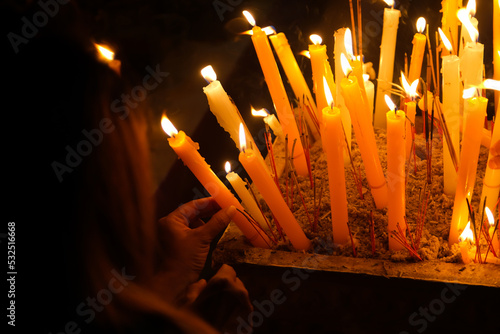 Burning Candles in the Buddhist Temple with a Woman