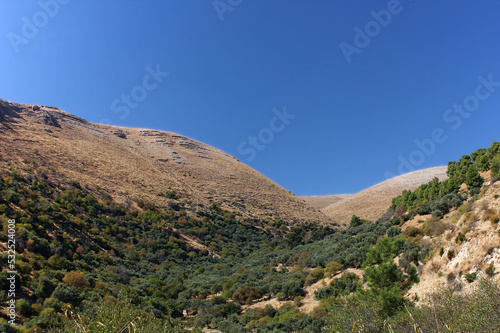 Hills on the western side of the Sea of Galilee and cloudless blue sky