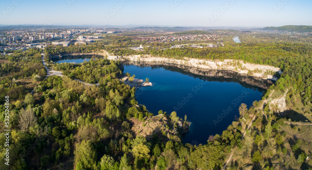 Krakow, Poland. Zakrzowek lake with steep cliffs in place of former flooded limestone quarry in Twardowski Rocks. Popular recreational place. Aerial panorama at sunrise