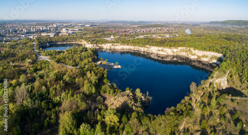 Krakow, Poland. Zakrzowek lake with steep cliffs in place of former flooded limestone quarry in Twardowski Rocks. Popular recreational place. Aerial panorama at sunrise