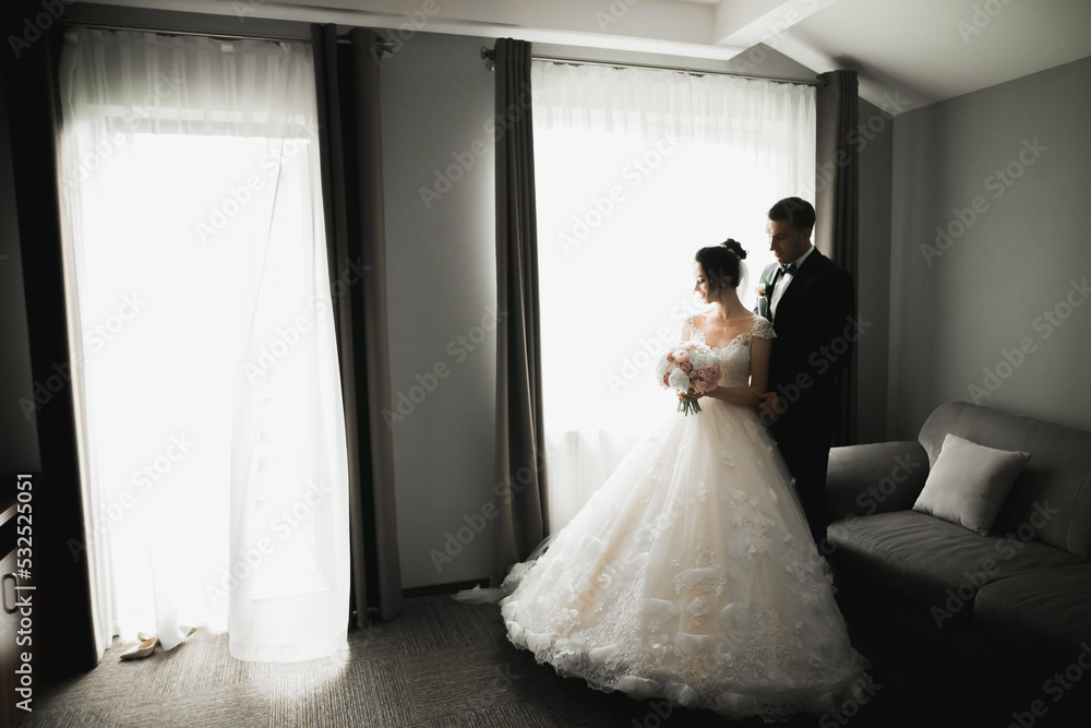 Wedding couple on the nature is hugging each other. Beautiful model girl in white dress. Man in suit Wedding couple on the nature is hugging each other. Beautiful model girl in white dress. Man in suit