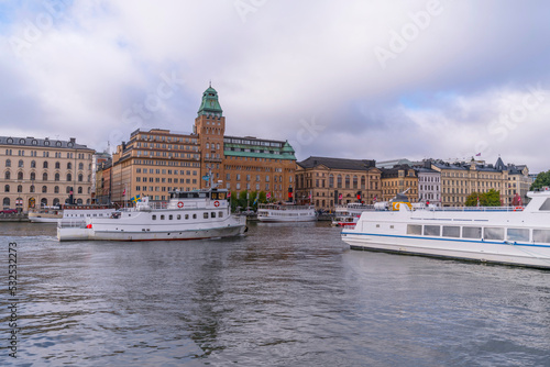 Archipelago commuter ferries in the bay Nybroviken and cumulus clouds an autumn day in Stockholm 