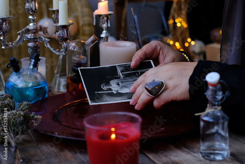 spiritualistic seance in salon of medium with old photographs, Female Fortuneteller, esoteric Oracle, longing for ancestors, communication with spirits, help ancestors, Family Ritual Scripts