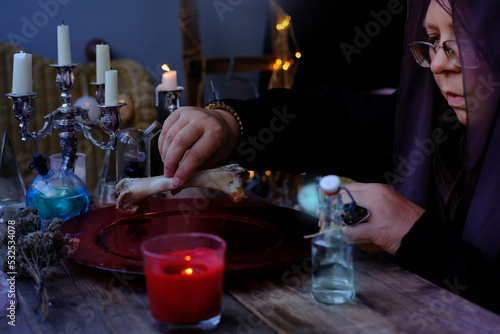 ed dish with water, candle lights in dark room of future fortuneteller, esoteric Oracle, session of black magic with bones of dead animals, divination for the future, activity at halloween party