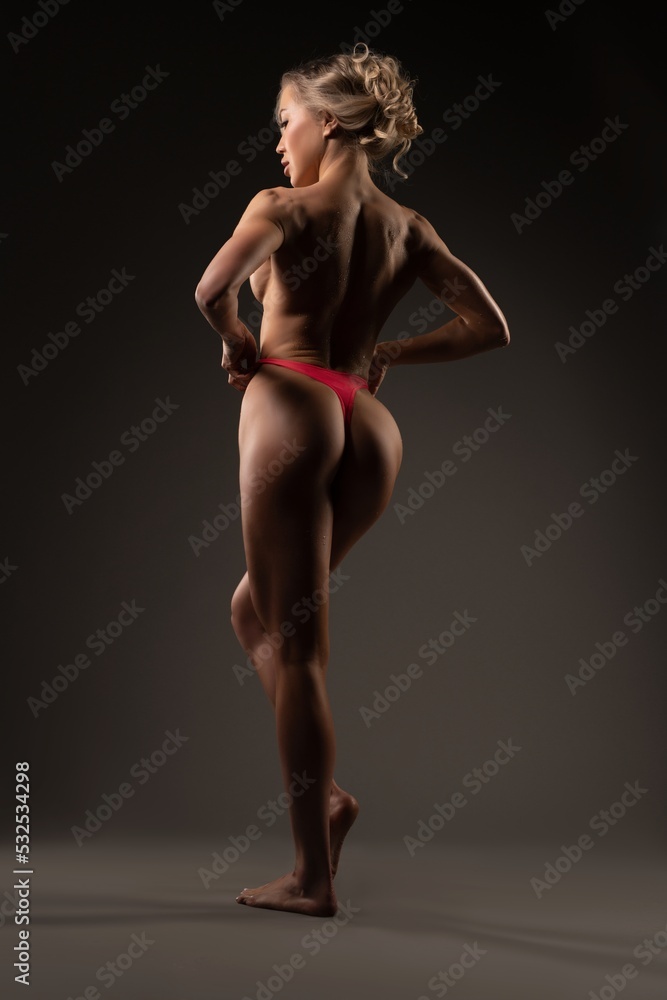 Cheerful muscular woman in rose tango show perfect spine