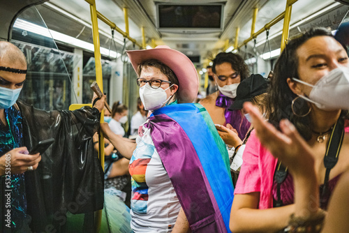 Friends in a subway going to Pride photo