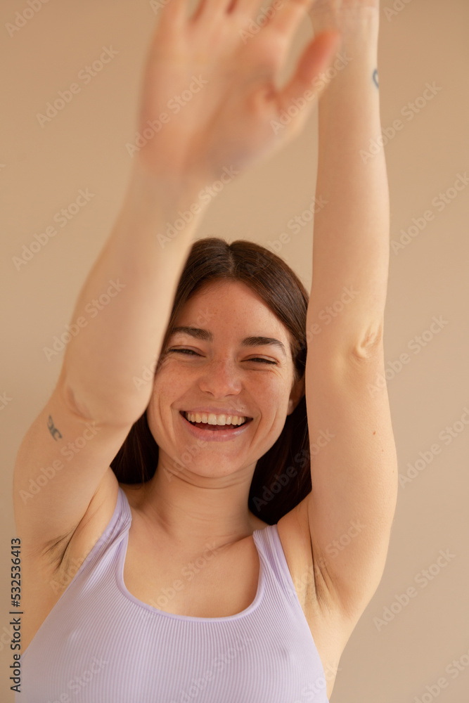 Sweet young woman giggling playfully and showing armpits Sweet young woman giggling playfully and showing armpits