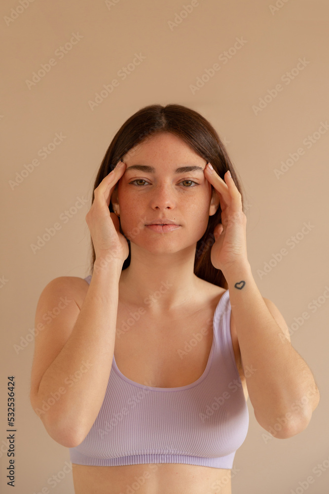 Woman using essential oils in her temples Woman using essential oils in her temples