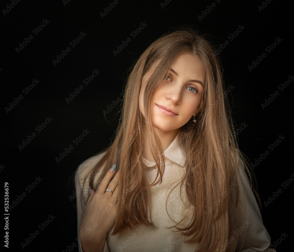 Portrait of a young beautiful fair -haired girl on a dark background. Portrait of a young beautiful fair -haired girl on a dark background.