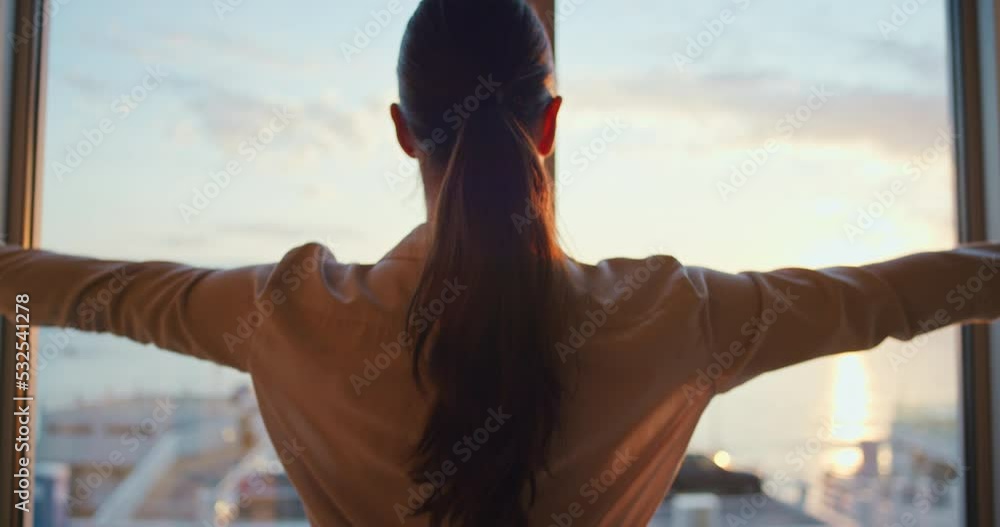 Curtain, window and view with a woman opening the drapes to see the sunset over the ocean or sea and horizon. Holiday, vacation and getaway with a female looking outside while traveling abroad