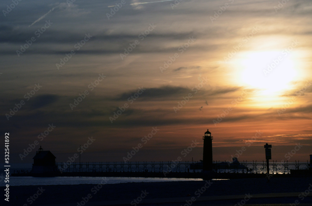 sunset over the lake with a lighthouse 