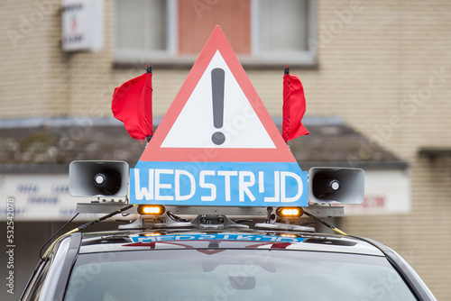 a warning sign used by cycling races or sport activities on the public roads photo