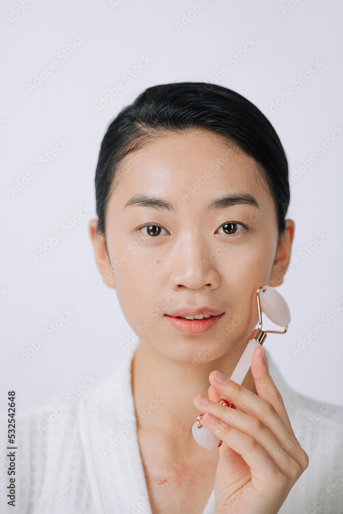 Woman caring of her beauty face with cosmetic tool Woman caring of her beauty face with cosmetic tool