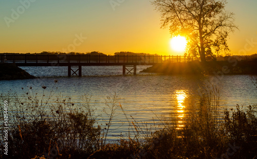 Sunrise over the bridge at river and lake