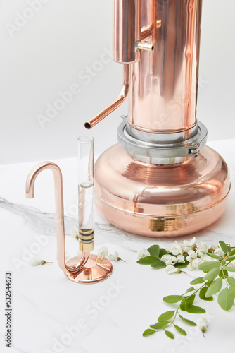 Vintage copper oil distiller with Acacia flowers.