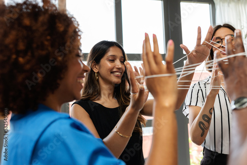Businesswomen connected with twine at office