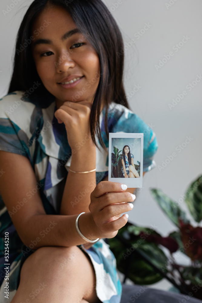 Asian woman showing instant pic