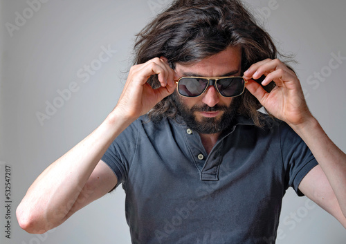 Young man wearing sunglasses in studio © fpunshon
