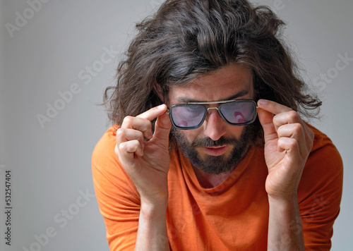 Young man wearing sunglasses in studio