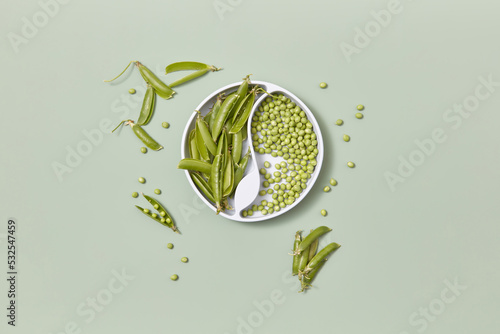 Kids plate with dividers with green peas. photo