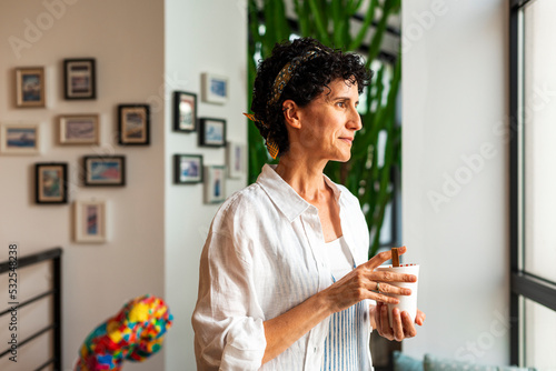 Mature woman drinking coffe cup photo