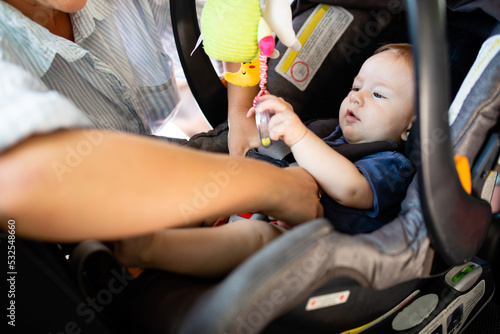 Infant Gets Strapped Into Car Seat By Parent