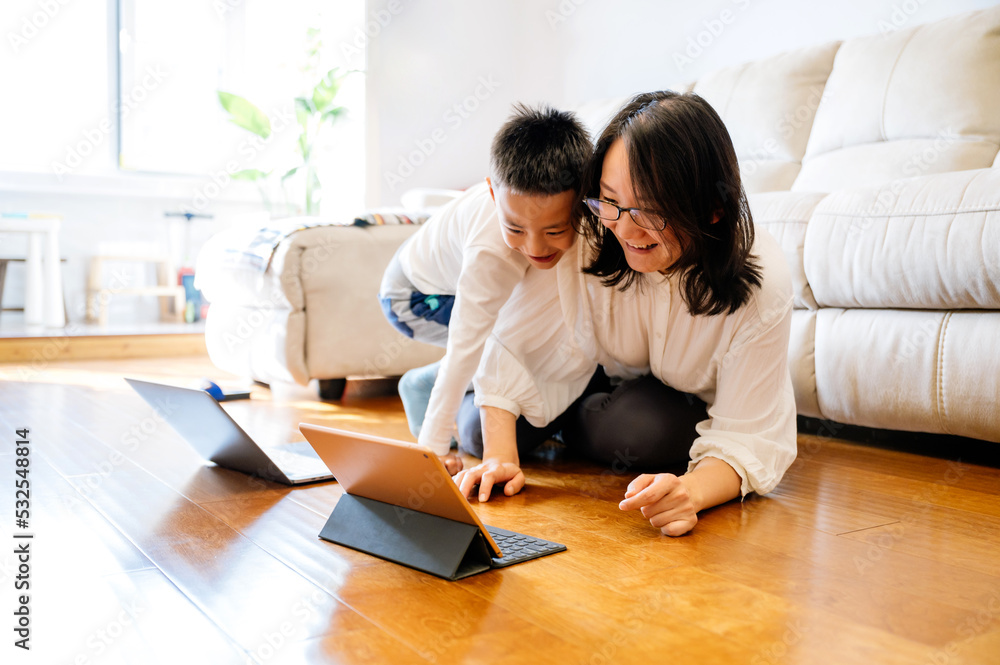 Mother and her toddler boy using laptop Mother and her toddler boy using laptop