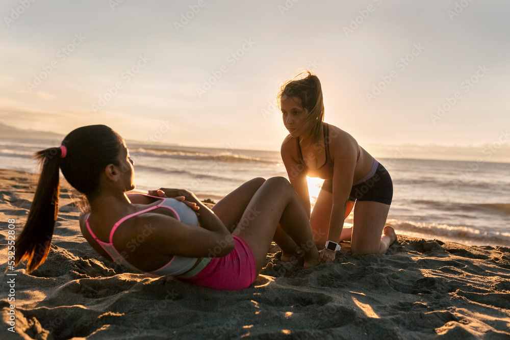 © Marco Govel/Stocksy - Women doing abdominal crunches