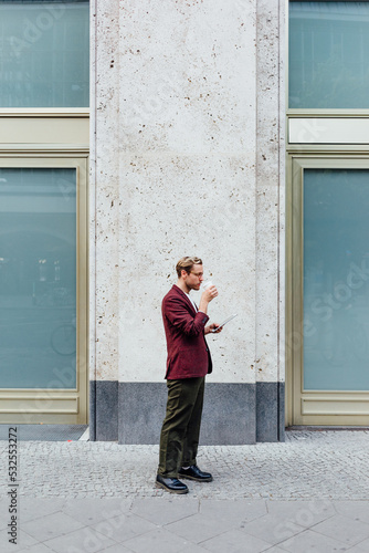 Man Dinking Coffee in Street photo