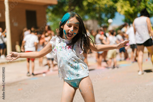 Funny dirty girl dancing on street photo