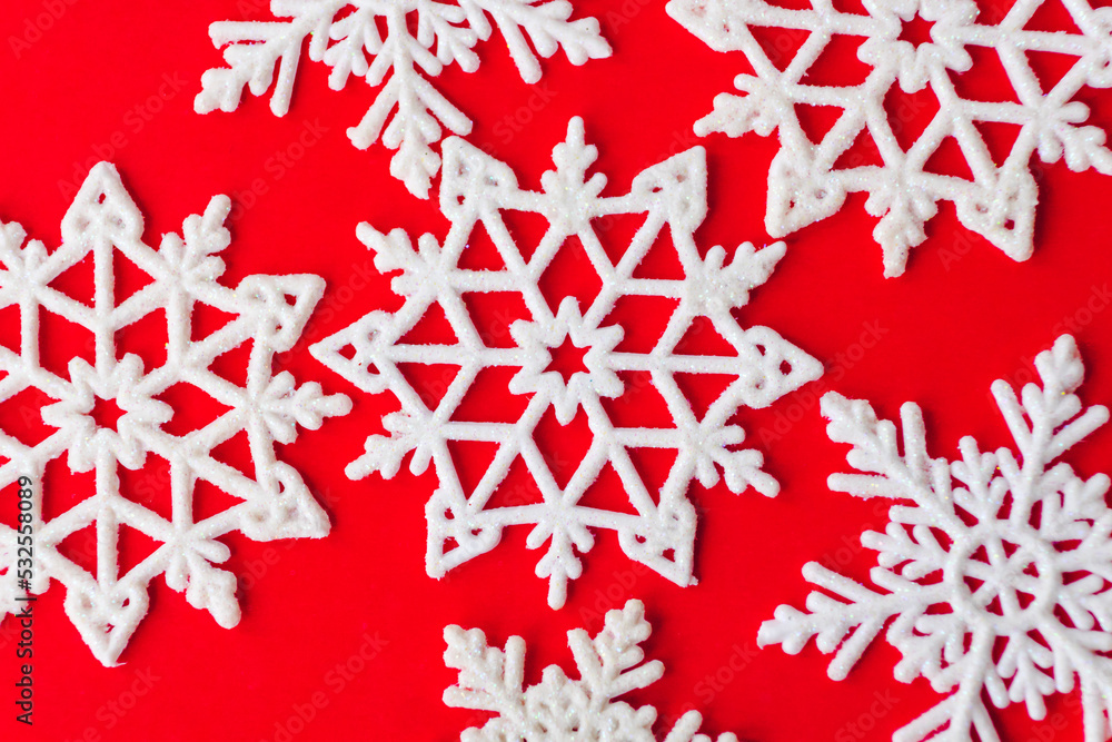 Ornament of white snowflakes on red paper card. Vintage Christmas postcard with snowflakes. Beautiful christmas white stars on a red background Ornament of white snowflakes on red paper card. Vintage Christmas postcard with snowflakes. Beautiful christmas white stars on a red background
