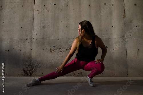 
woman performs muscle stretching photo