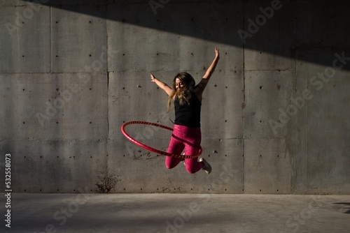 woman jumps with her hula hoop  photo
